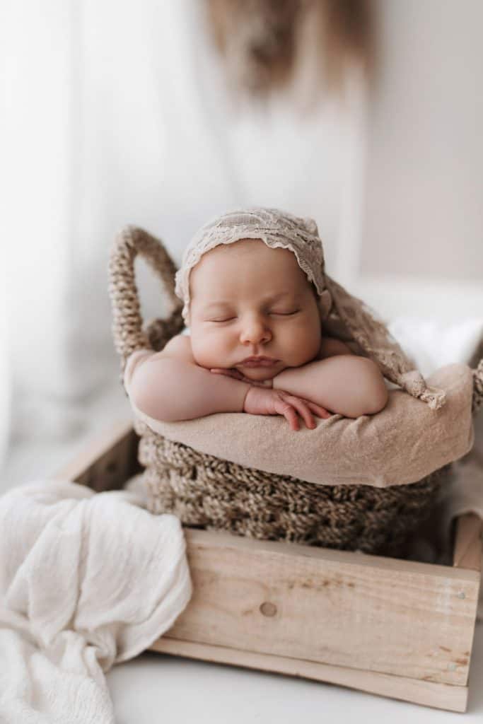 Boho Kulisse mit schlafendem Baby das eine Mütze trägt